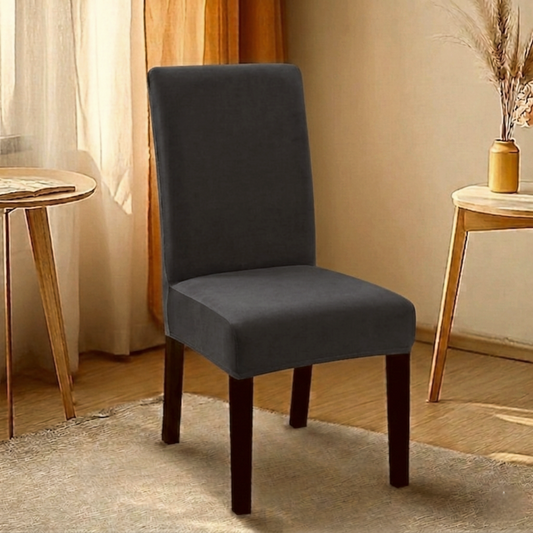 Dark gray fitted jersey chair cover with stretchable fabric and elastic edges for a snug fit on standard chairs