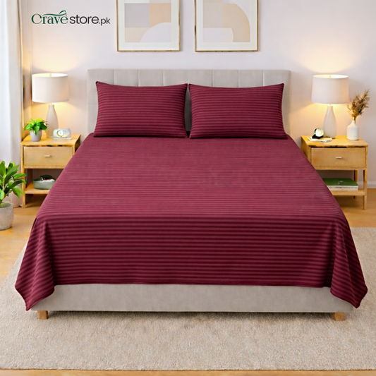 Maroon striped king size flat bedsheet with two matching pillow covers on bed