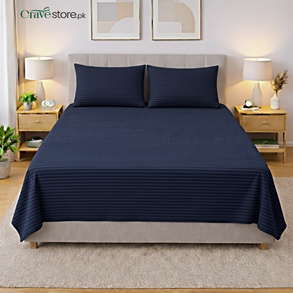 Navy blue striped king size flat bedsheet with two matching pillow covers on bed