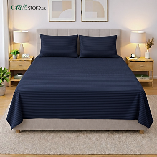 Navy blue striped king size flat bedsheet with two matching pillow covers on bed